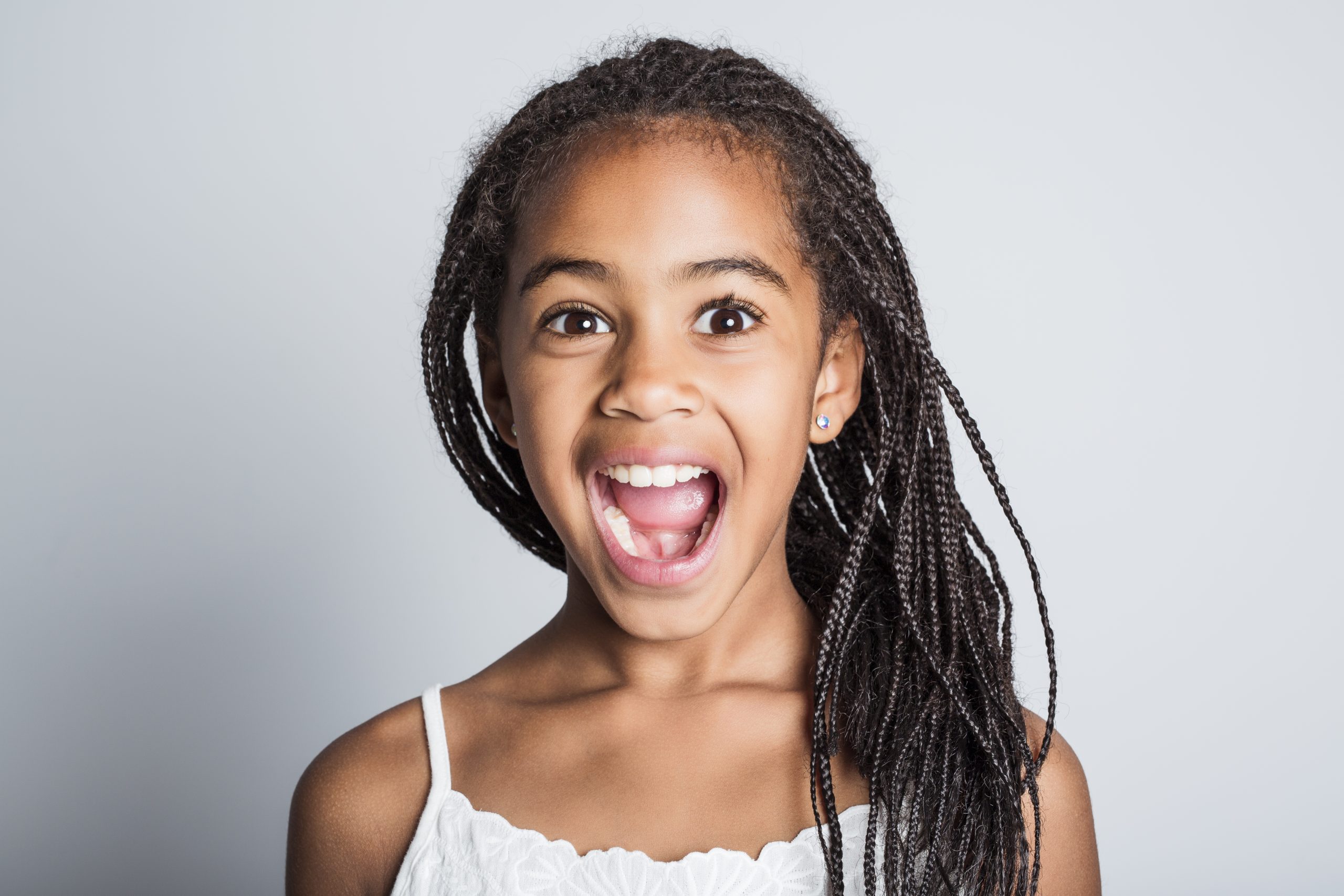 An Adorable african little girl on studio gray background